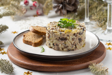 Fototapeta na wymiar Salad with mushrooms, beef, potatoes and onions for new year, Christmas. Winter holiday, celebration, traditional Russian food. Portion feed