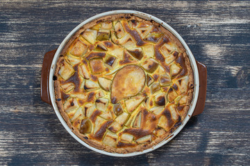 Homemade organic pear pie dessert ready to eat. Pear tart on the old wooden background, close up