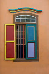 Colorful wooden abstract window, closeup . Colonial style architecture building in Little India , Singapore . Background and texture of bright architecture