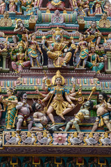 Fototapeta na wymiar Colourful statues of Hindu religious deities adorning the entrance of a Hindu temple in Little India, Singapore city