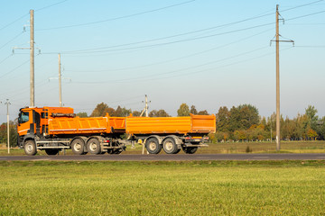  Orange dump truck goes on highway