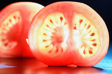 Red tomato cut in half with the texture of seeds