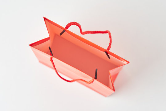 Top view inside open red paper shopping bag on white background.