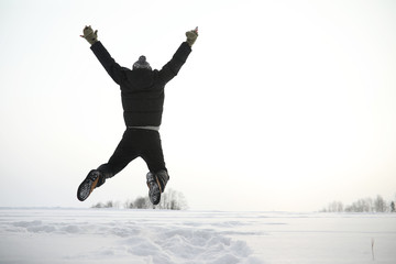 Fototapeta premium A man on a walk. Winter landscape. Tourist in winter journey.