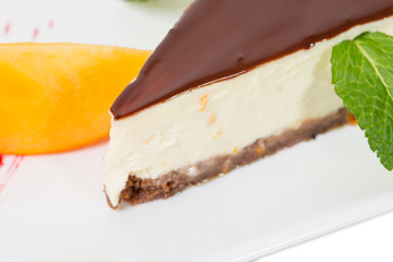 Delicious cheesecake with mango and red jam.