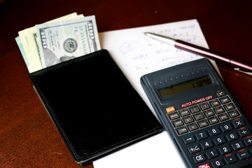 calculator on the table glasses money