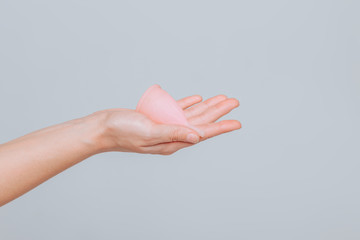 Close up of woman hand holding menstrual cup