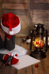 girl writes pen on a piece of paper Christmas wishes