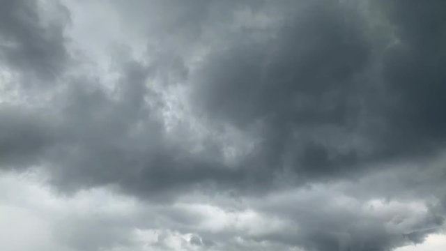 dramatic big storming dark rain clouds on sky timelapse