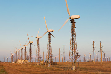 wind farm, many turbo generators stand in a row, alternative wind energy