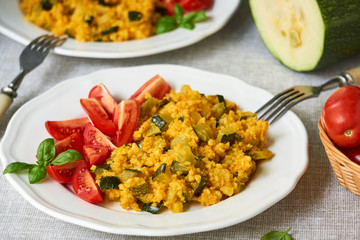 Spicy millet porridge with zucchini and tomatoes