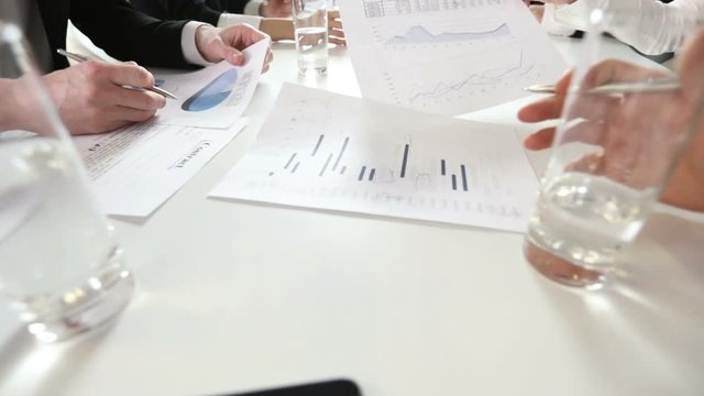 Business people working together with financial data statistics using reports with diagrams