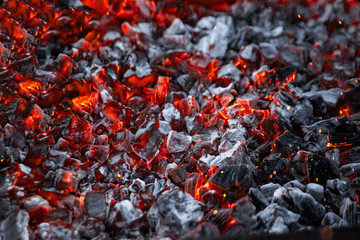 Texture red hot coals, selective focus. Barbecue grill dark background