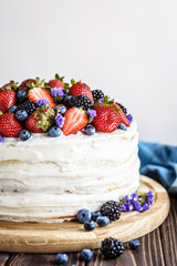 Rustic Cake With Fresh Berries on a wooden background