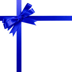 Deep blue gift ribbon bow vertical top corner border frame isolated on white.