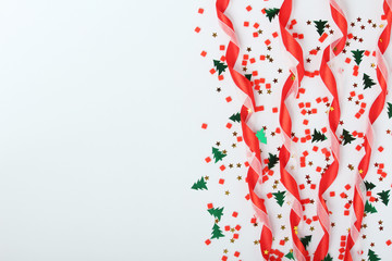Red ribbon and confetti New year background with copy space