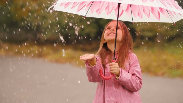 Little girl under umbrella at rain