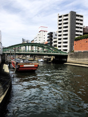 Obraz premium Tokyo port with beautiful old boats and classic buildings on the sumida￼ river
