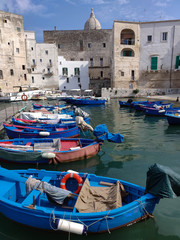 Fototapeta na wymiar Small port with fishing boats in the city of Monopoli in Italy