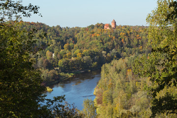 City Sigulda, Latvia Republic. Old castle, build from red bricks. Around trees with yellow leafs. 27. Sep. 2019