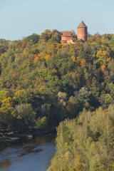 Obraz premium City Sigulda, Latvia Republic. Old castle, build from red bricks. Around trees with yellow leafs. 27. Sep. 2019