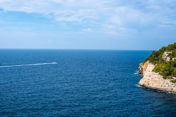 Mediterranean sea with boat and rocks