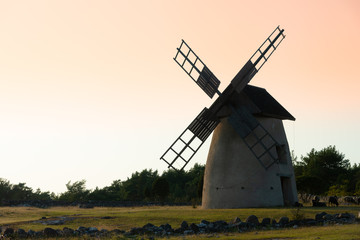 Fototapeta na wymiar Old windmill on the island Faroe, Sweden, on an early summer morning.