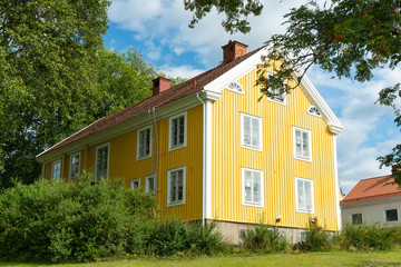 Traditional yellow wooden house in the small town Virserum in Sweden