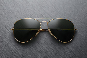 Classic sunglasses on black slate background
