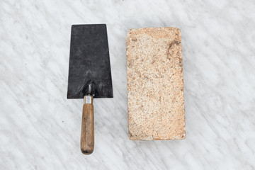 Brick trowels lie on a light background top view. copy space. Concept construction building repair.