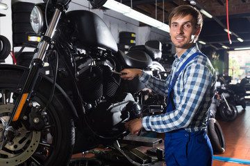 Fototapeta na wymiar young male mechanic working in auto repair shop