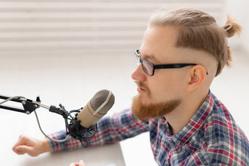 Radio host, streamer and blogger concept - Close-up of handsome man working as radio host at radio...