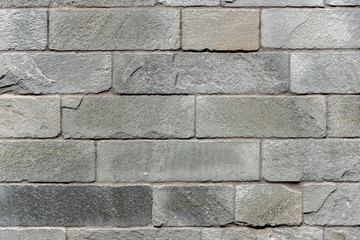 Closed up grey brick wall texture. Architectural material construction.