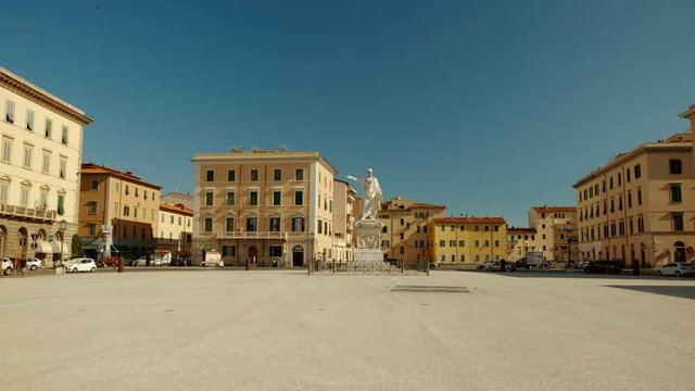 Walking along the famous Piazza della Repubblica in Livorno towards the statue of Ferdinand III, Grand Duke of Tuscany, Italy