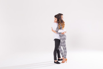 Young couple dancing latin dance bachata, merengue, salsa, kizomba. Two elegance pose over white...
