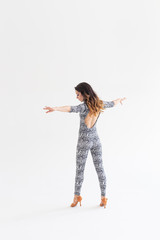 Latina dance, strip dance, contemporary and bachata lady concept - Woman dancing improvisation and moving her long hair on a white background