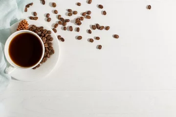 Papier Peint photo Lavable Bar a café Blue scarf, coffee grains and a cup on a white table, morning start day. Autumn mood background, copy space, flat lay.