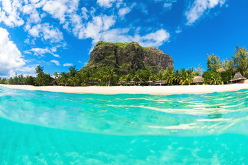 Tropical ocean with Le Morne mountain and white sand beach in Mauritius.