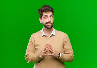 young businessman scheming and conspiring, thinking devious tricks and cheats, cunning and...