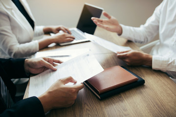 Serious asian businessman important conversation with male employee are reviewing resume documents.