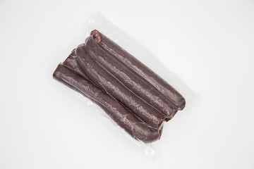 Deer  sausage is packed in a vacuum for winter on a white background. Wild meat concept.