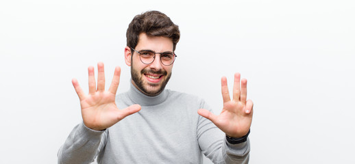 young manager man smiling and looking friendly, showing number nine or ninth with hand forward,...