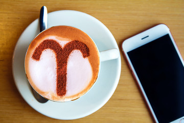 zodiac sign Aries on a foam of hot cappuccino