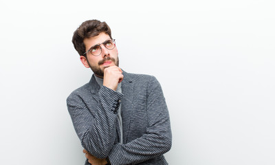 young manager man thinking, feeling doubtful and confused, with different options, wondering which...