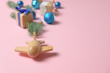 wooden children's plane on a pink background