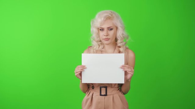 Woman showing blank white big A4 paper. Leaflet presentation. Pamphlet hold hands. Girl show clear offset paper. Angry emotions