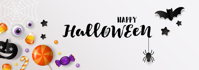 Fototapeta na wymiar Halloween banner design with candy and paper cut decorations background.