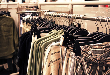 Making a purchase at a clothing store. store of women's clothing. In foreground is hanger with clothes