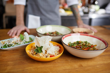 Background image of several Asian dishes set on wooden table in cafe or restaurant, copy space