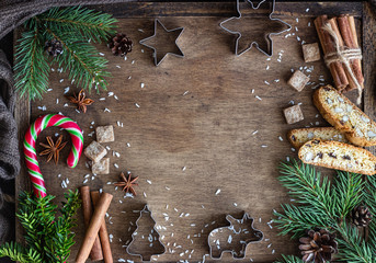 Christmas food background with fir branches, cones, winter spices and candies. Copy space for your text. Festive background.